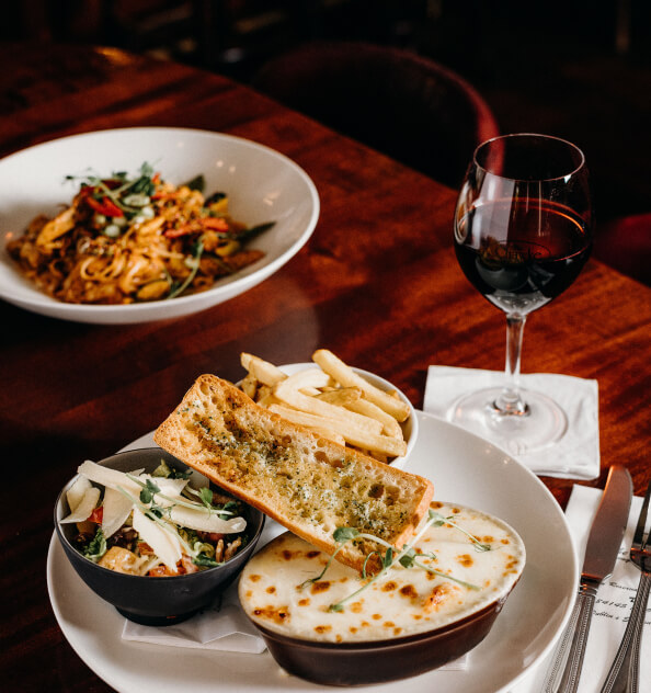 image of lasagne with chips and wine